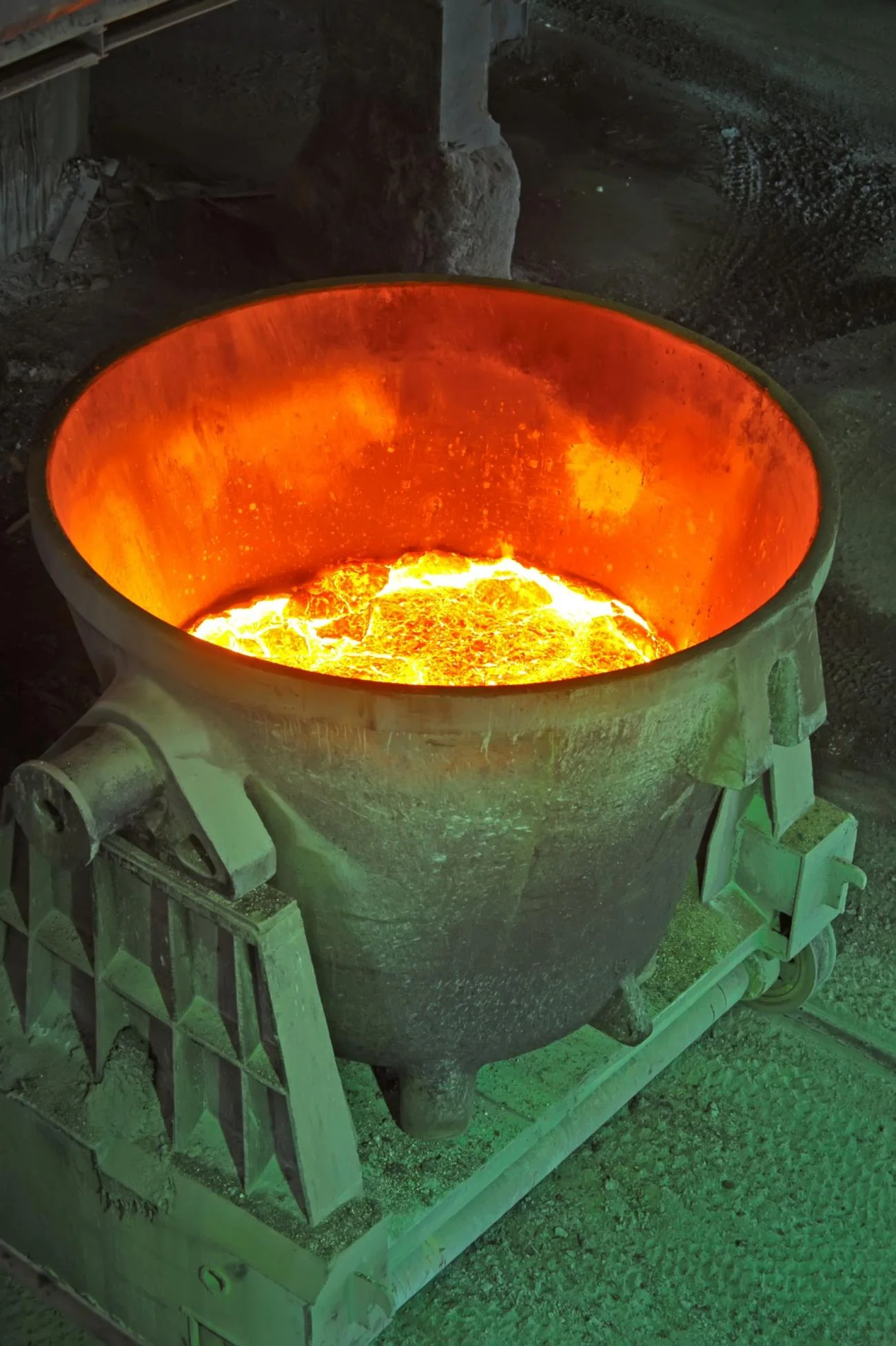 Glowing molten metal in a crucible at a steel plant